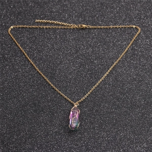 Detail of rainbow crystal quartz pendant with gold wire wrap on black glitter background