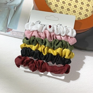 Set of 6 velvet and satin scrunchies in varied colors on a white display card