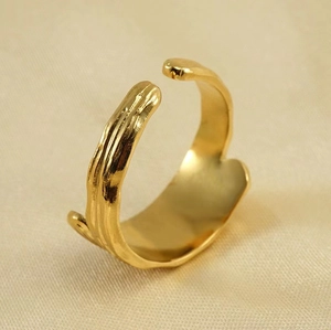 Close-up of 18K gold-plated adjustable ring with organic molten metal texture details