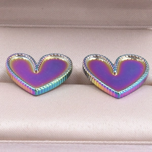 Detail of heart-shaped iridescent 304 stainless steel earrings with beaded edges