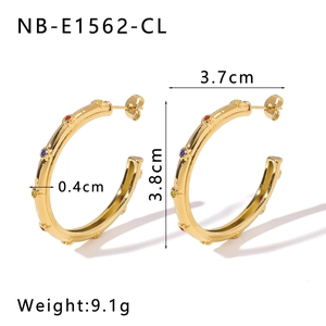 Macro view of C-shaped gold stainless steel earrings with colorful crystals and dimensions