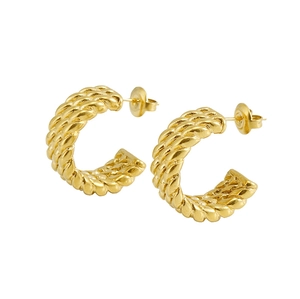 Detail view of gold-plated stainless steel C-shape twisted hoop earrings on white background