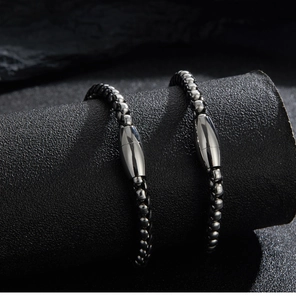 Detailed view of multilayer black braided leather bracelet with stainless steel magnetic clasp