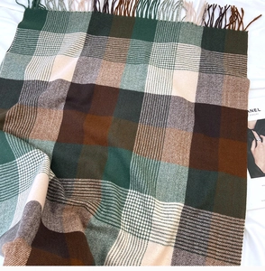 Detail of plaid scarf texture with fringed edges and soft cashmere-like fabric