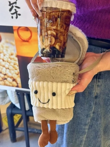 Detail view of plush cartoon coffee cup sleeve bag with soft faux fur and crossbody strap