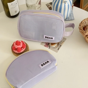 Mesh makeup bag set in light purple with yellow zippers and BEAR rubber patch label
