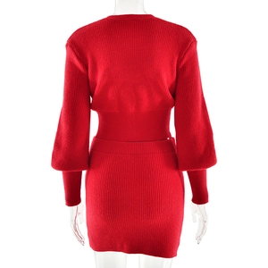 Back view of a red ribbed knit two-piece set featuring long lantern sleeves and a mini skirt