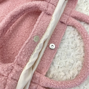 Close-up of pink faux fur tote bag showing magnetic clasp and satin lining texture