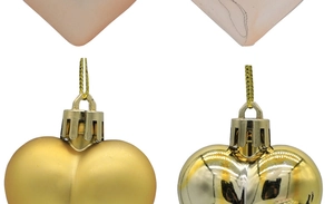 Detail of matte and glossy gold heart ornaments with golden hanging ropes for Christmas tree