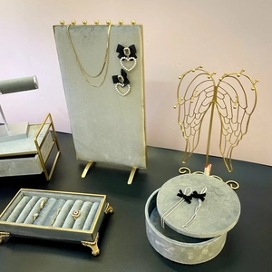 Gray velvet and gold metal jewelry display set for necklaces, rings and earrings