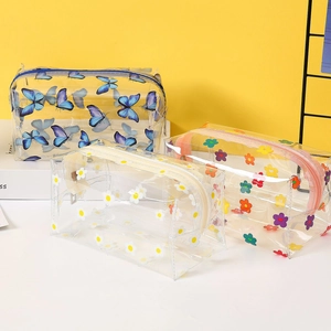 Three waterproof PVC clear makeup bags with floral and butterfly prints for travel