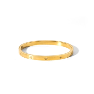 Detail of 18k gold plated stainless steel bangle with engraved star and tiny gemstone