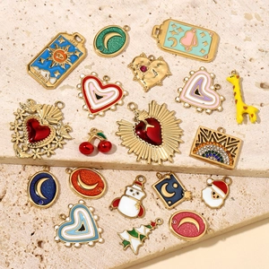 DIY stainless steel pendants featuring heart, moon, and tarot sun designs on marble