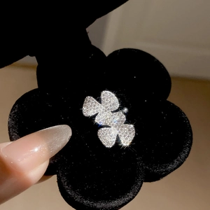 Macro shot of silver zircon clover ear cuff clip with sparkling diamond inlay