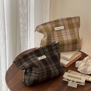 Retro plaid wool cosmetic bag with Simple Wish label on wooden table with decor