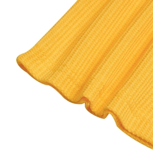 Close-up of yellow waffle knit fabric texture on a men's polo shirt with sharp detail