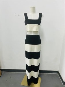Detail showing the knitted texture of black and white striped two-piece skirt set