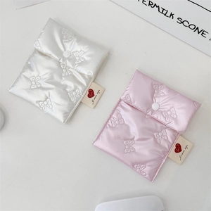 Detail of pink and white quilted heart bow storage bags with satin finish and snap closure