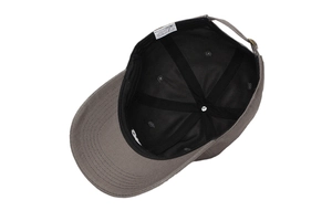 Internal detail of grey cotton baseball cap showing stitching, wash label and adjustable strap