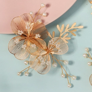 Handmade bridal hair clips with golden hollow flowers and elegant white pearls decoration