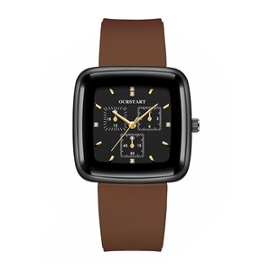 Macro detail of square black dial with golden markers and brown silicone strap watch
