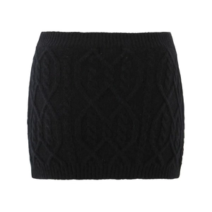 Detailed close-up of a black knit mini skirt featuring a classic cable knit texture