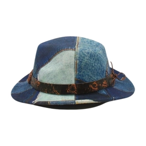 Detail of denim patchwork fedora with brown vintage band and embossed tiger head icon