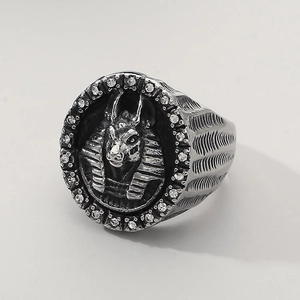Macro shot of vintage Anubis ring showing silver-tone relief and white zircon inlay