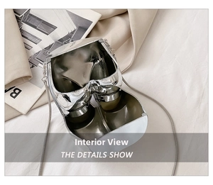 Detailed interior of heart-shaped silver metal bag with chain strap and dual compartment