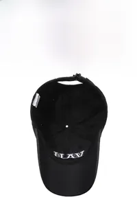 Detail of adjustable metal buckle and cotton material labels inside black baseball cap
