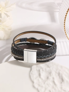 Detail of dark gray multilayer leather bracelet with sparkling crystals and magnetic clasp