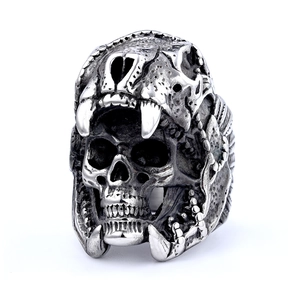 Macro shot of punk style double skull ring with vintage silver finish and detailed fangs