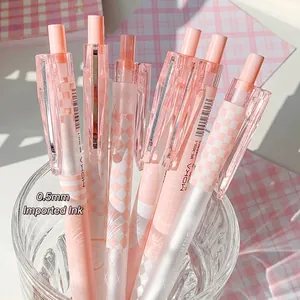 0.5mm peach pink gradient retractable gel pens with checkerboard pattern in glass cup