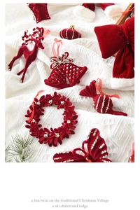 Detail view of red flocked Christmas ornaments with gold glitter on white texture