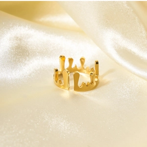 Macro view of gold irregular liquid lava open ring on elegant champagne silk