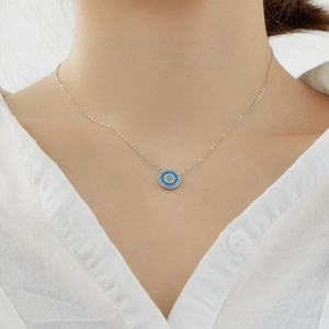 Detailed view of S925 sterling silver evil eye necklace featuring blue zircons on a model