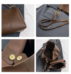 Detail view of large brown PU leather tote with dual straps and magnetic closure