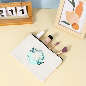 Detail shot of canvas makeup bag with butterfly print showing interior storage space