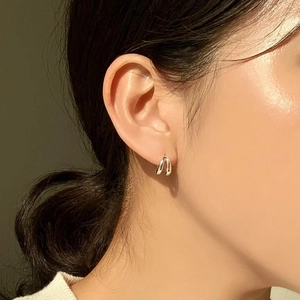 Minimalist 925 sterling silver double-layer earrings worn by model in warm natural light
