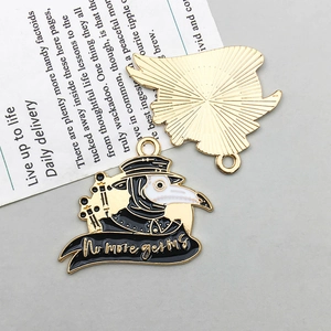Macro detail of Plague Doctor enamel pendants with No More Germs text and gold back