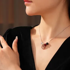 Bohemian stainless steel necklace with dalmatian stone beads and rose gold coin pendant