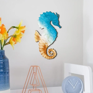 Detailed view of seahorse wall art featuring ocean wave patterns on a white wall