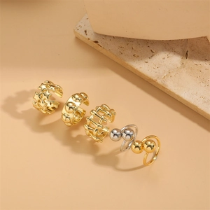 Minimalist gold and silver polished open rings set with star and braided mesh designs