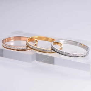 Three minimalist 18k gold plated pavé crystal bracelets in gold, silver, and rose gold