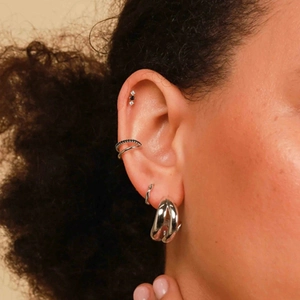 Close-up of 925 sterling silver ear piercing set with colorful zircon and ball screw back