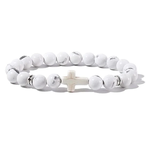 Mens white turquoise beaded bracelet with silver cross pendant on a white background