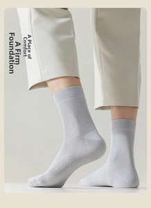 Close-up of light grey crew socks featuring breathable mesh texture and ribbed cuffs