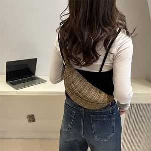 Brown striped woven crescent chest bag with adjustable strap for daily commute