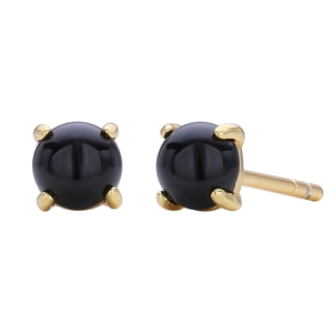 Detailed view of black round stud earrings with gold four-prong minimalist setting
