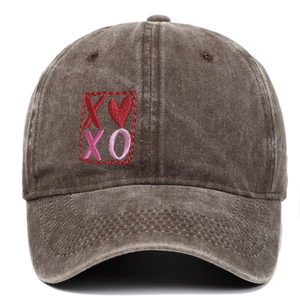 Detail of XOXO heart embroidery on vintage washed cotton baseball cap in charcoal gray